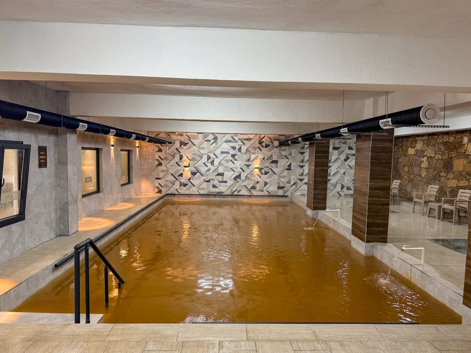 Indoor thermal pool in Karahayıt filled with mineral-rich reddish water